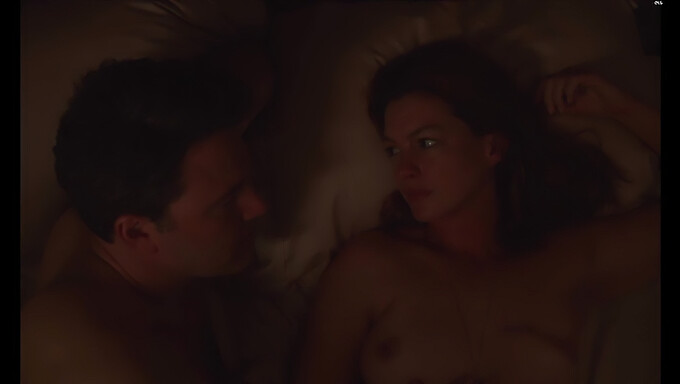 American Actress Anne Hathaway Exposes Her Large Breasts And Goes Topless In A Scene From "The Last Thing He Wanted"